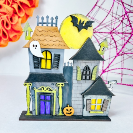 layered gray and black haunted halloween house with ghosts bats and pumpkins