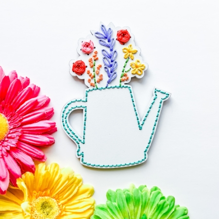 wood embroidery shape, watering can with flowers coming out of the top
